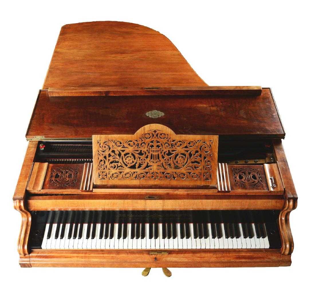 Overhead view of an old Schweinhofer piano with a florid decorative music stand
